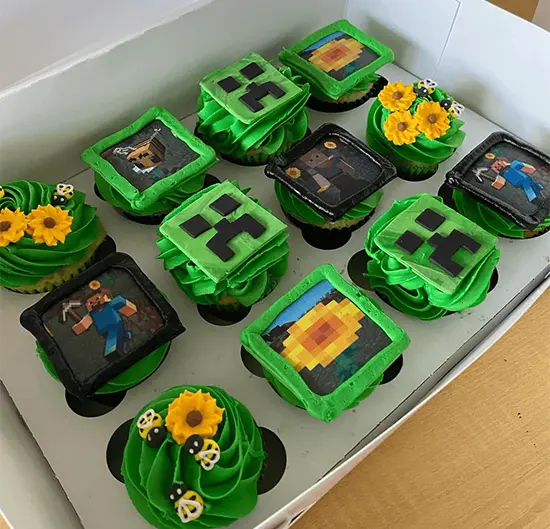Pixel cupcakes topped with edible cubes, swords, or pickaxes